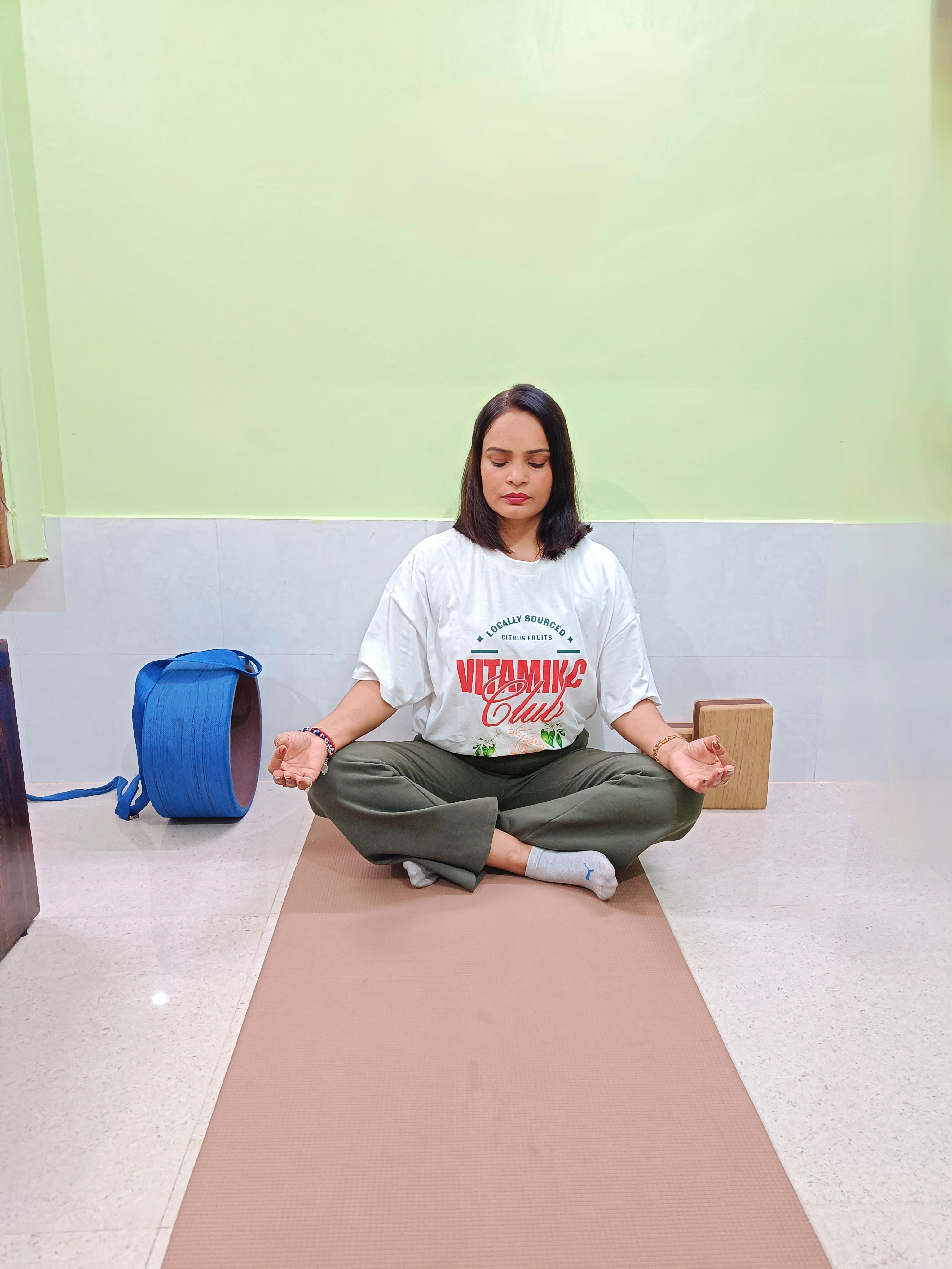 Serene woman meditating during pregnancy in a peaceful natural environment